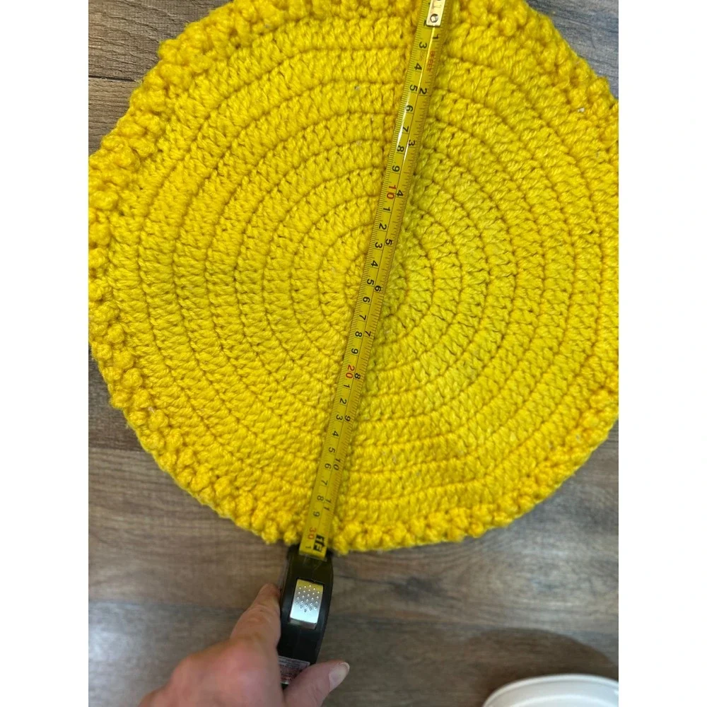 Two yellow crocheted placemats